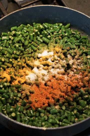 Yardlong beans and spices in a pan.