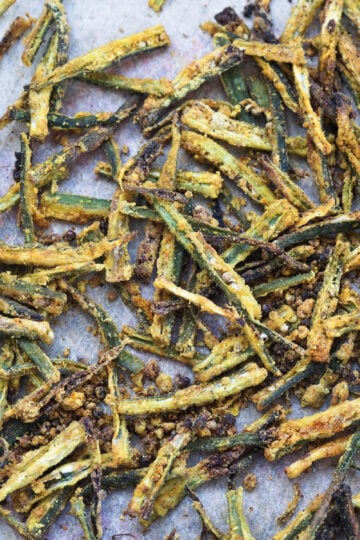 Air fryer kurkuri bhindi on a sheet.