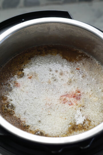 Spices added to dal in pressure cooker.