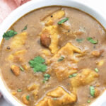 Bowl of Gujarati dal dhokli with cilantro leaves.