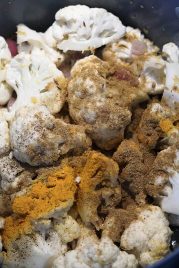 Spices added to cauliflower florets.