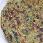 Upclose image of methi dhebra on a plate.