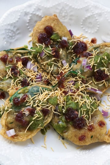 Chutneys and sev added to chaat.