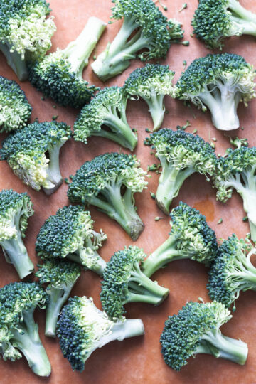 broccoli florets on a cutting board.