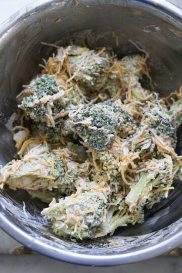 Broccoli and cheese and malai in a bowl.