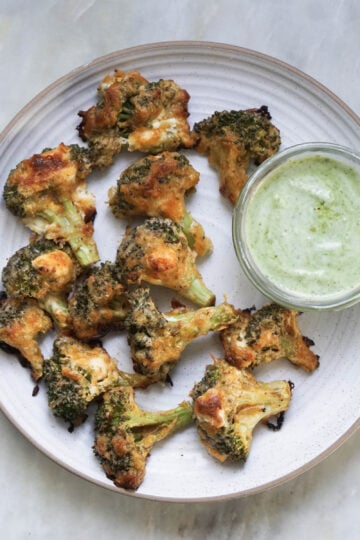 Malai broccoli in a plate with mint yogurt chutney.