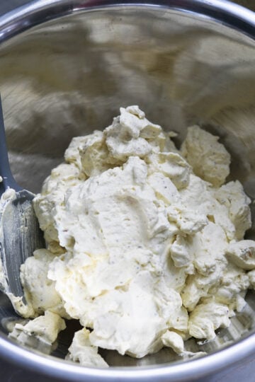 Thandai heavy whipping cream in a steel bowl.